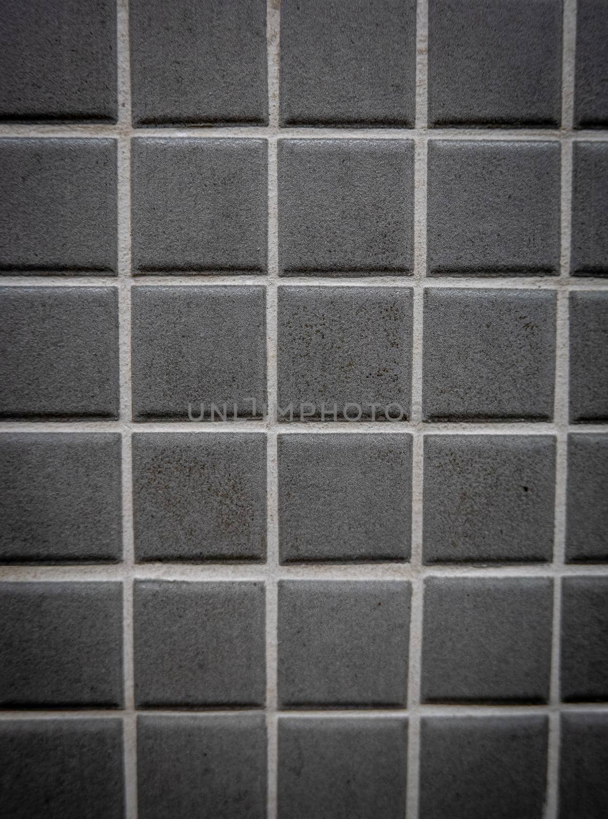 Gray ceramic mosaic on the wall as background.