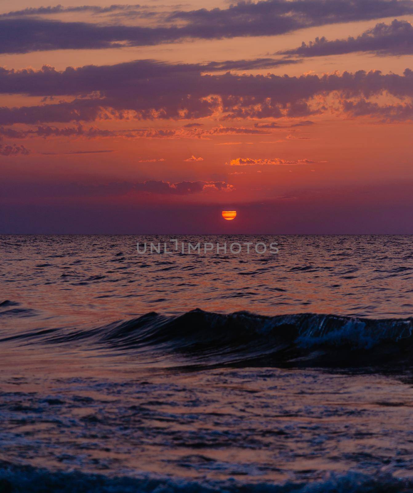 Sunset in red color over sea. by alexAleksei