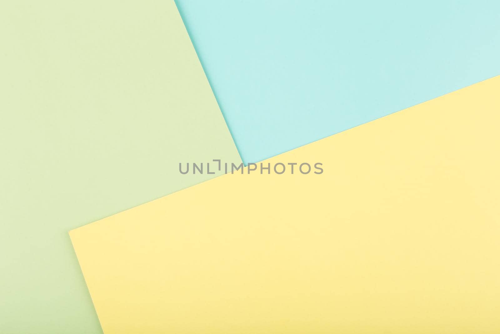 Elegant multicolored background made of bright yellow, green and green paper. Concept of template for website, banner, ad with space for text