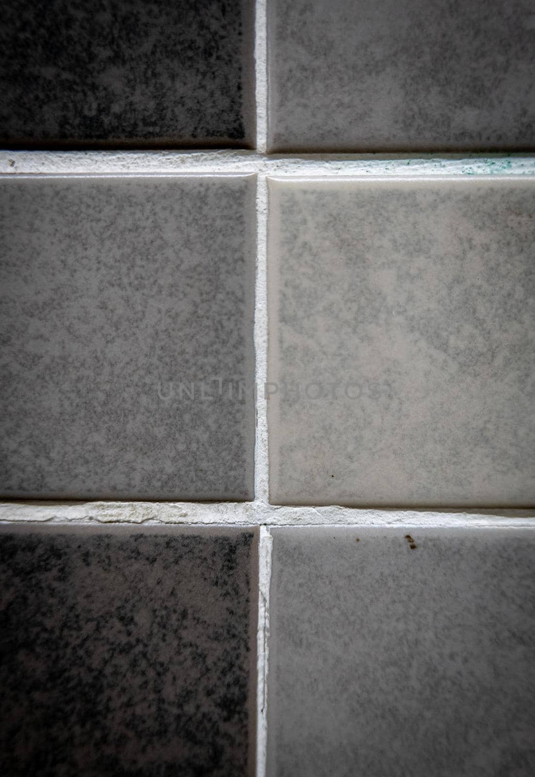 Gray ceramic mosaic on the wall as background.
