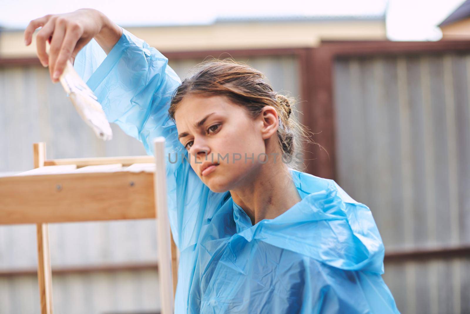 woman painter painting wood home renovation texture. High quality photo