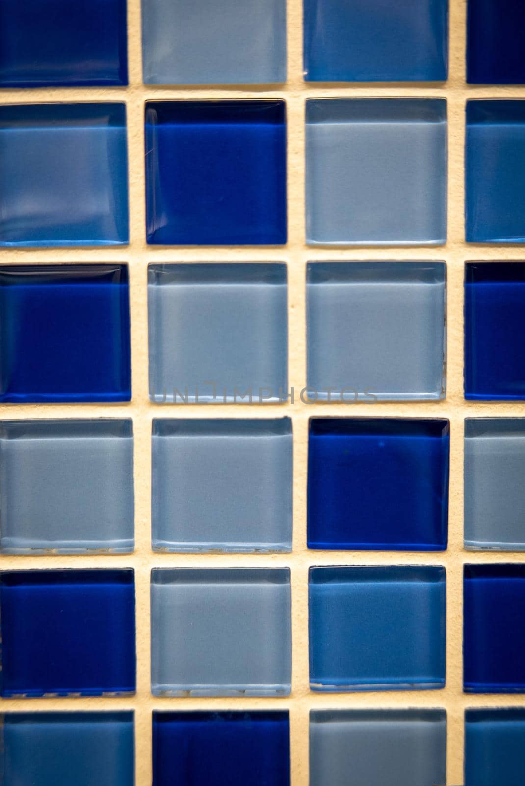 Blue ceramic mosaic on the wall as background.