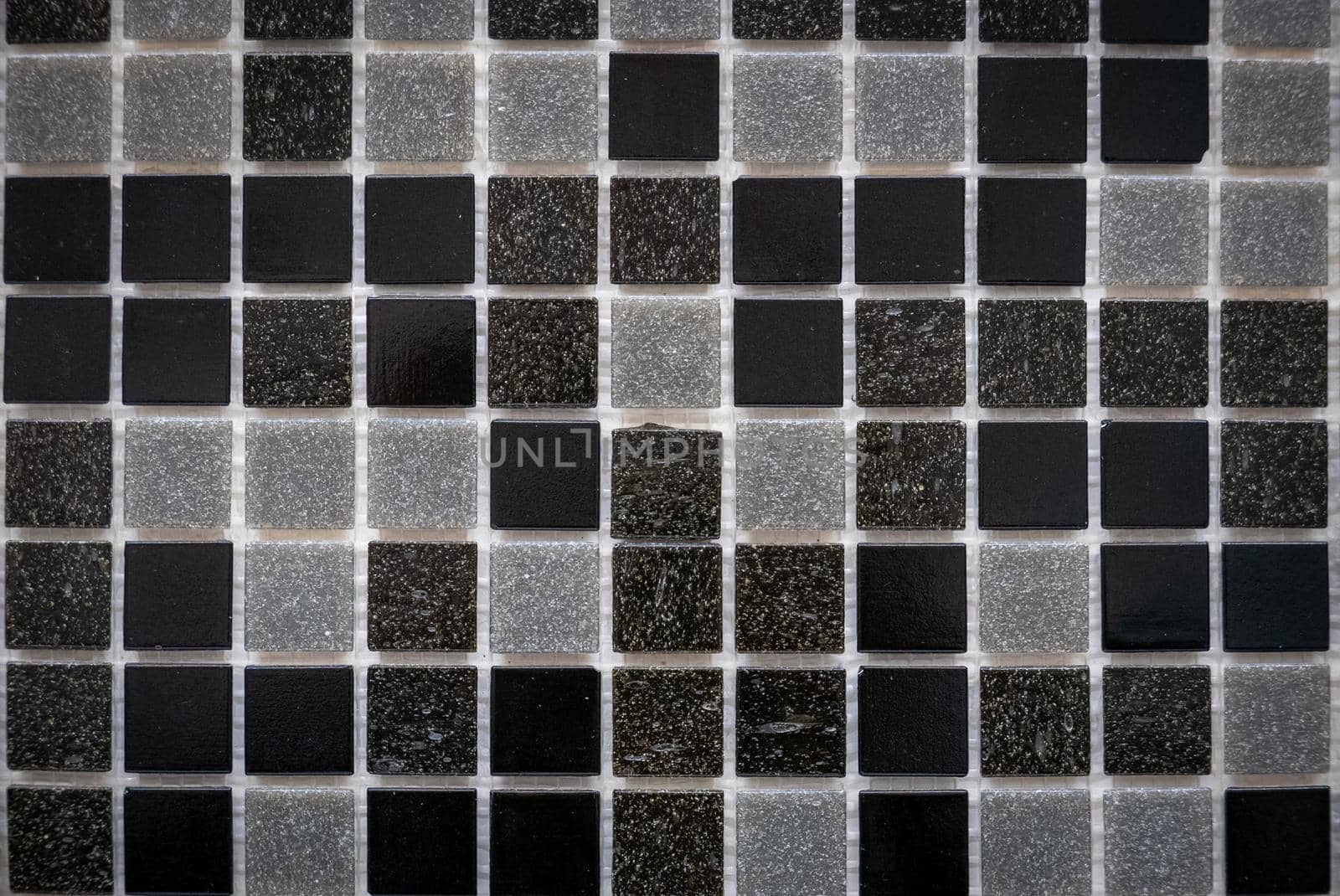 Gray ceramic mosaic on the wall as background.