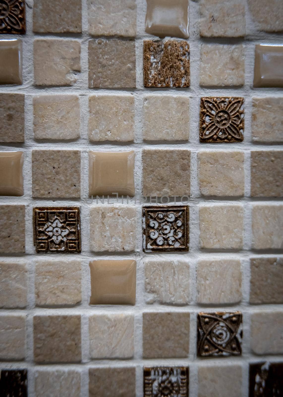 Brown ceramic mosaic on the wall as background.