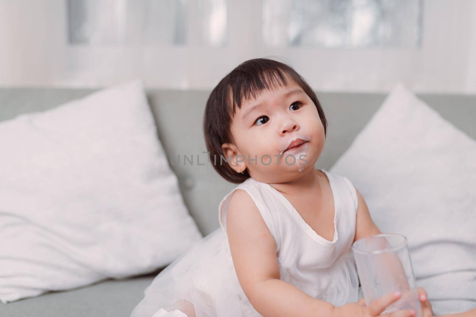 Little asian girl drinking milk by makidotvn