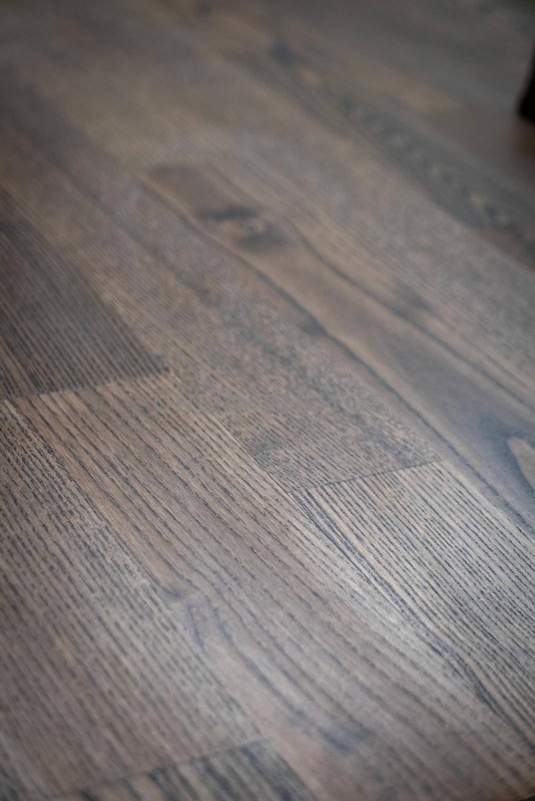 Dark brown wooden parquet floor texture as background.