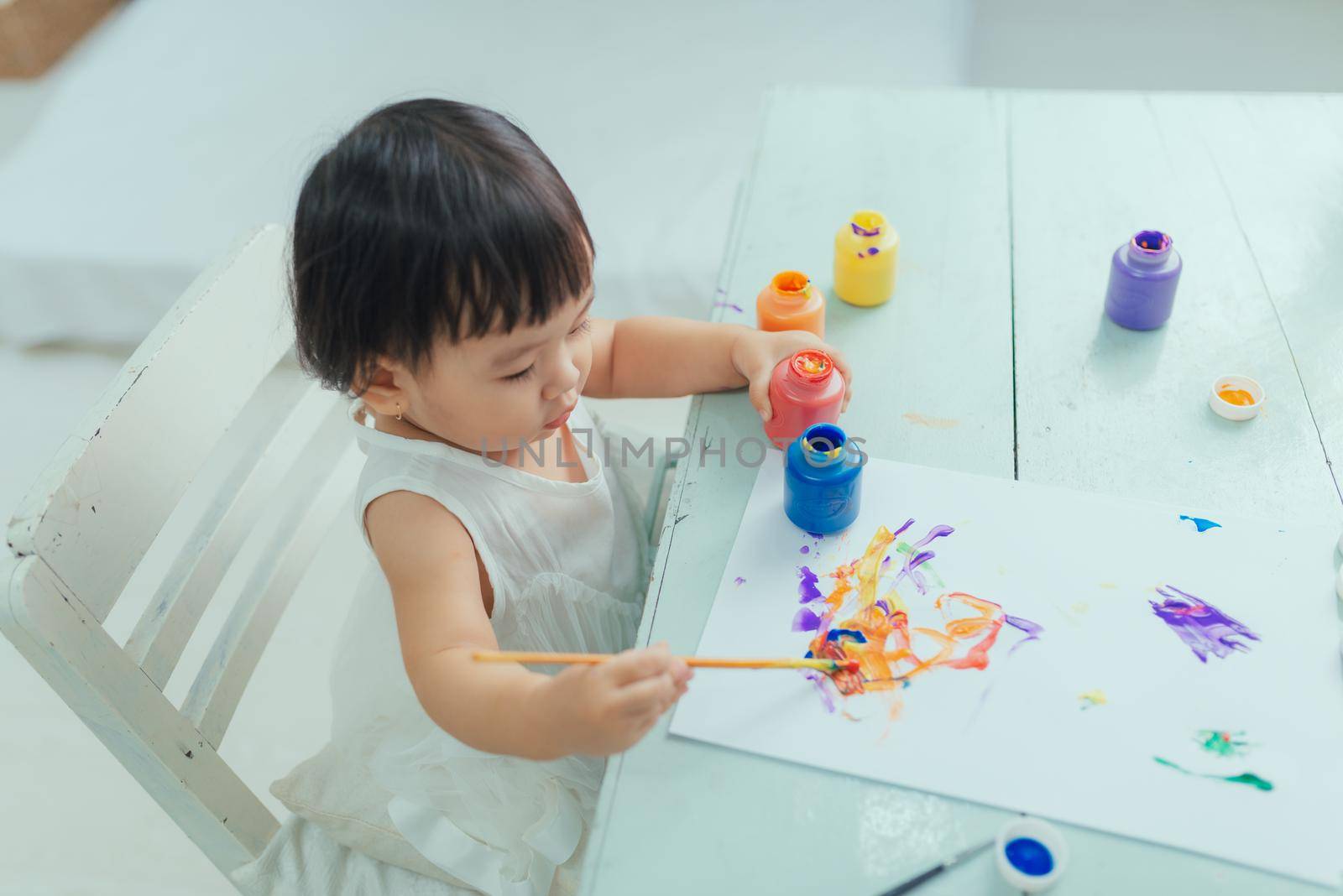 Little toddler child drawing at home