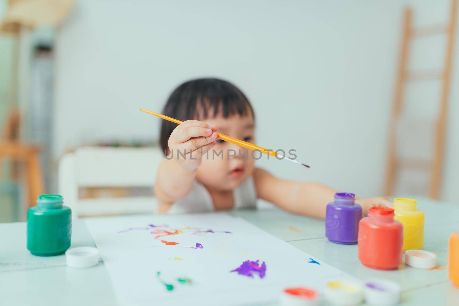 Cute adorable baby girl learning painting with water colors by makidotvn