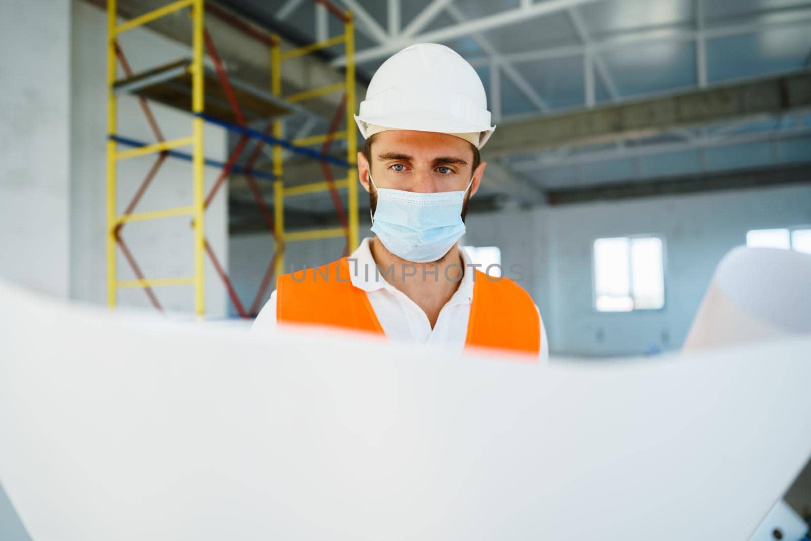 Portrait of young construction engineer wearing hardhat, close up