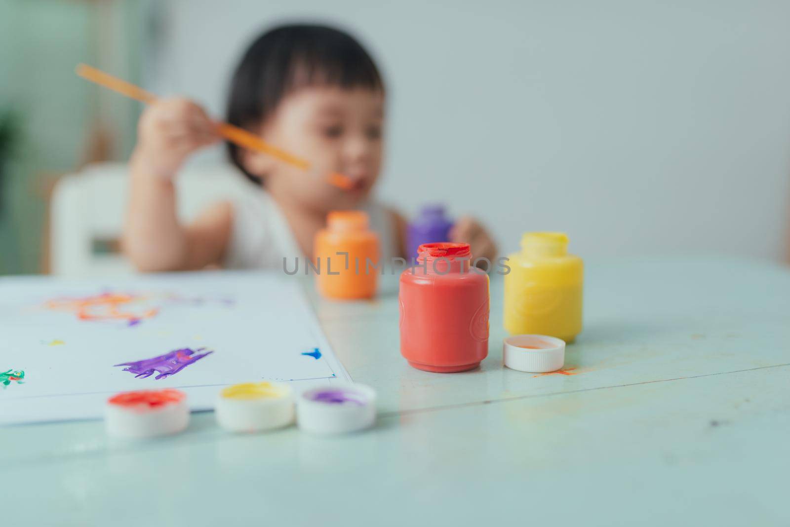 Healthy happy daughter experimenting with colors, water at home  by makidotvn