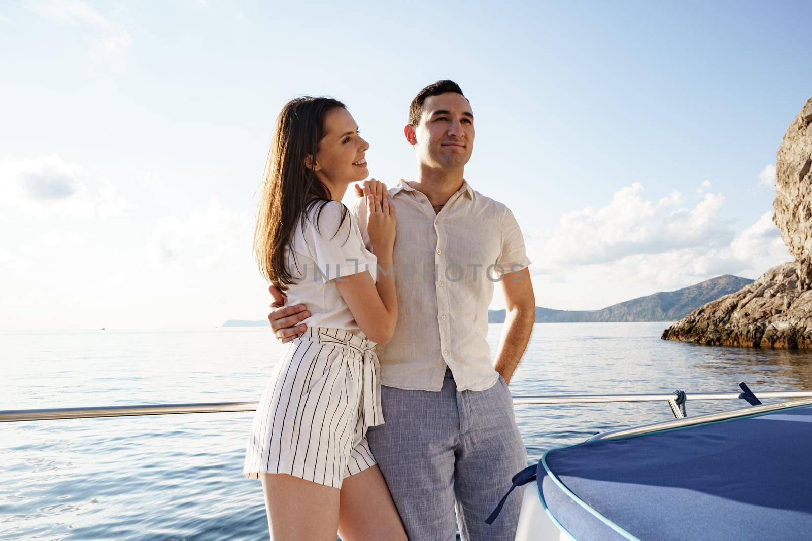 Happy couple in love on a yacht in summer on romantic vacation