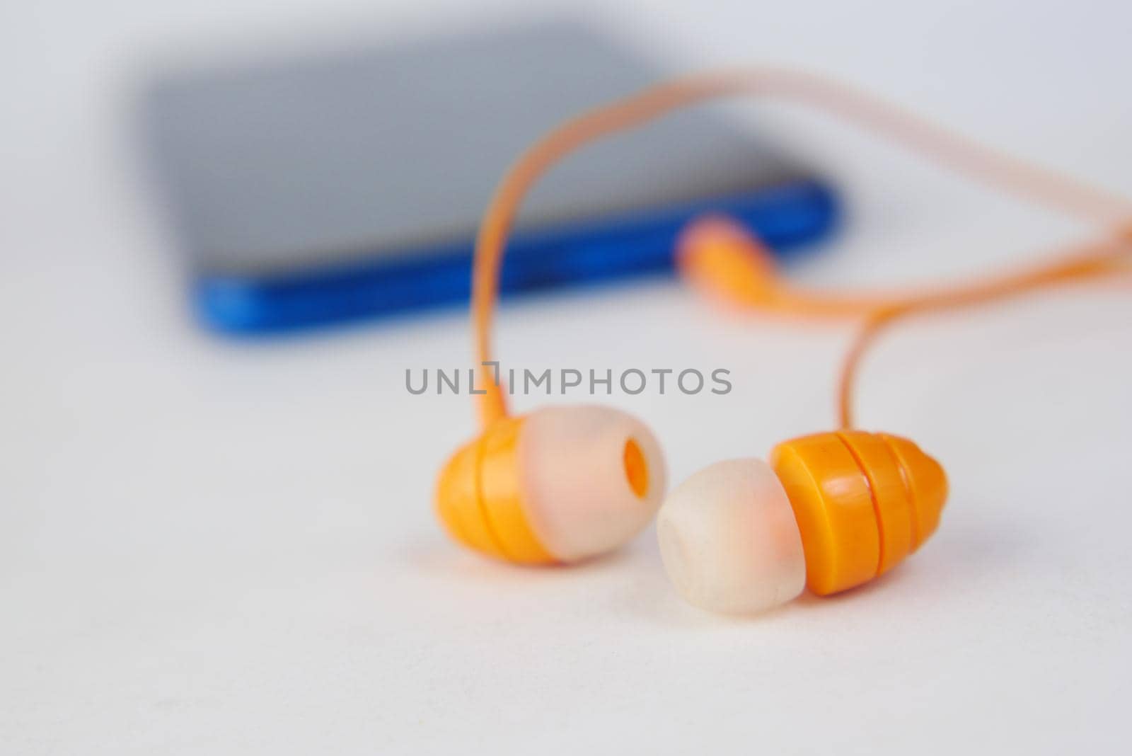smart phone and headphone on wooden background