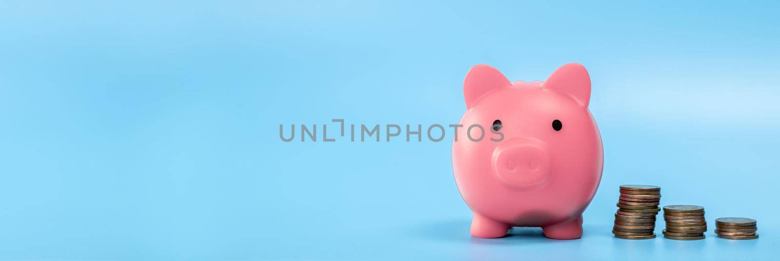 Pink Piggy Bank with stack of coins, growth and saving concept, Business and financial with copy space. web banner with space for text