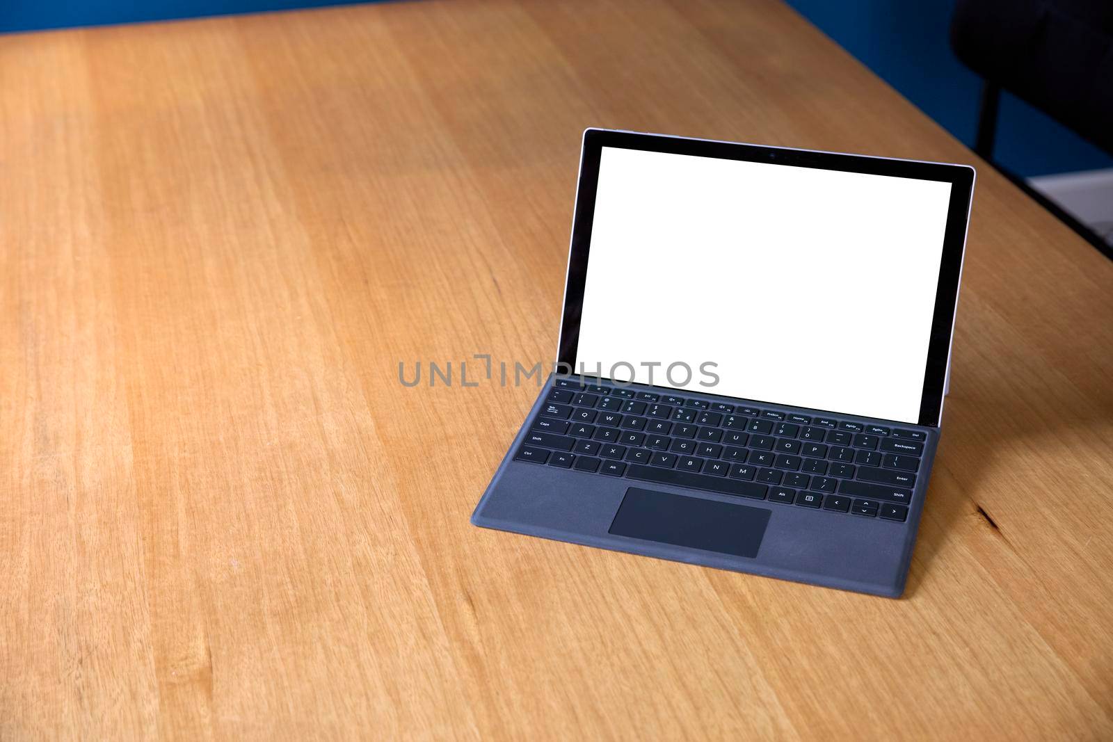 Open laptop isolated white screen for copy space on wooden office desk with copy space. work space home or office space for text advertisement