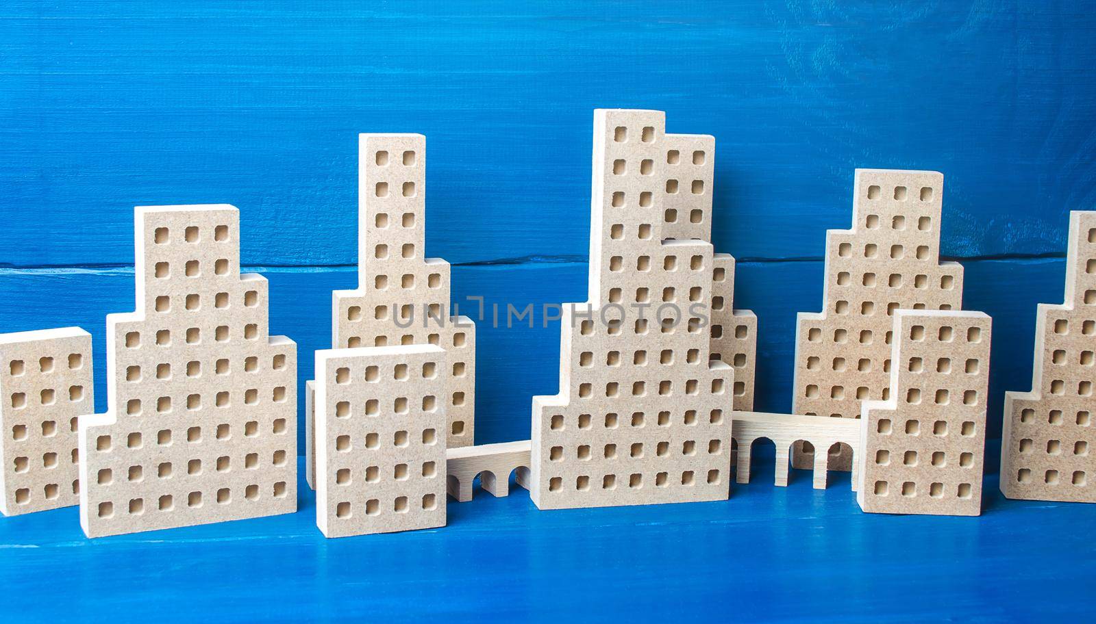 City of figures of buildings on a blue background. Concept for real estate, urban environment and transport infrastructure. City management and planning. Construction industry, growth and development.