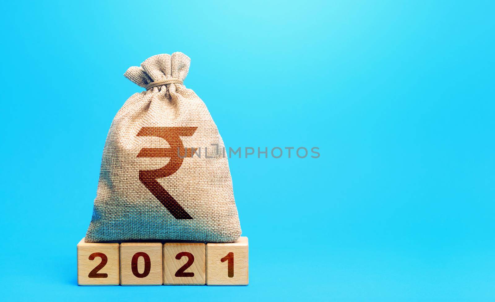 Indian rupee money bag and blocks 2021. Budget planning for next year. Revenues expenses, investment and financing. Beginning of new decade. Business plans and development prospects, trends