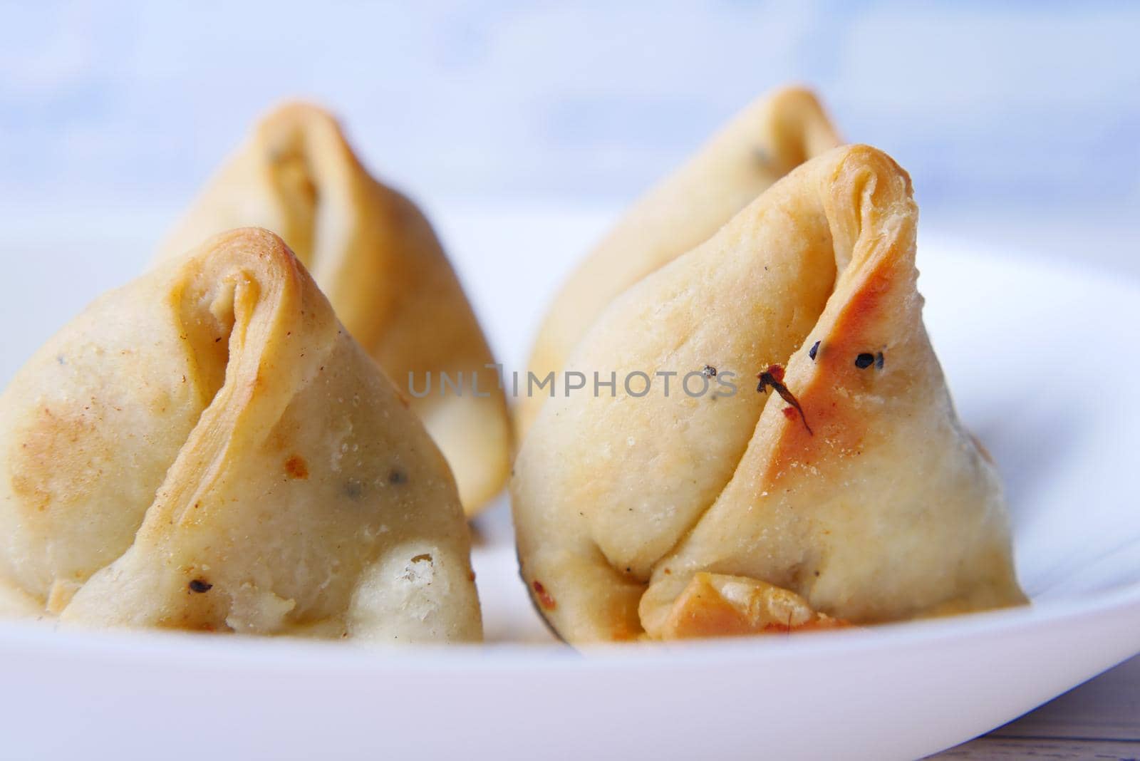 detail shot of a indian food singara on plate .