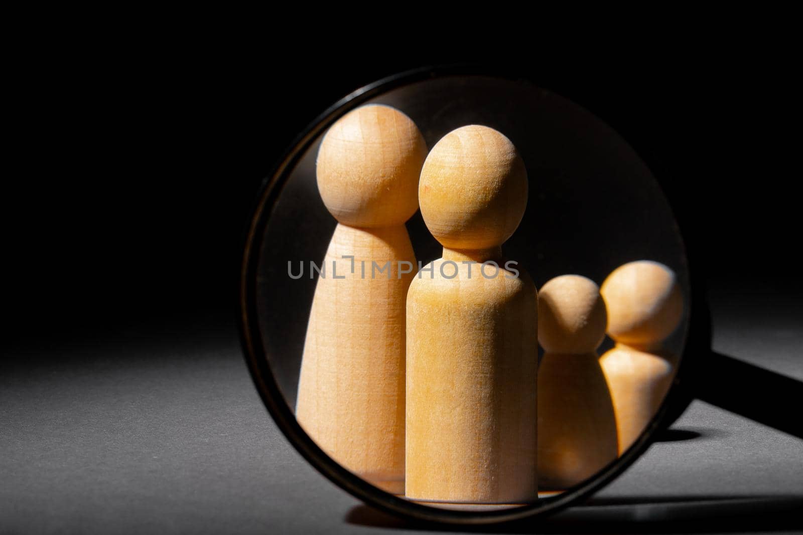 Wooden little figures of people close up. Family concept