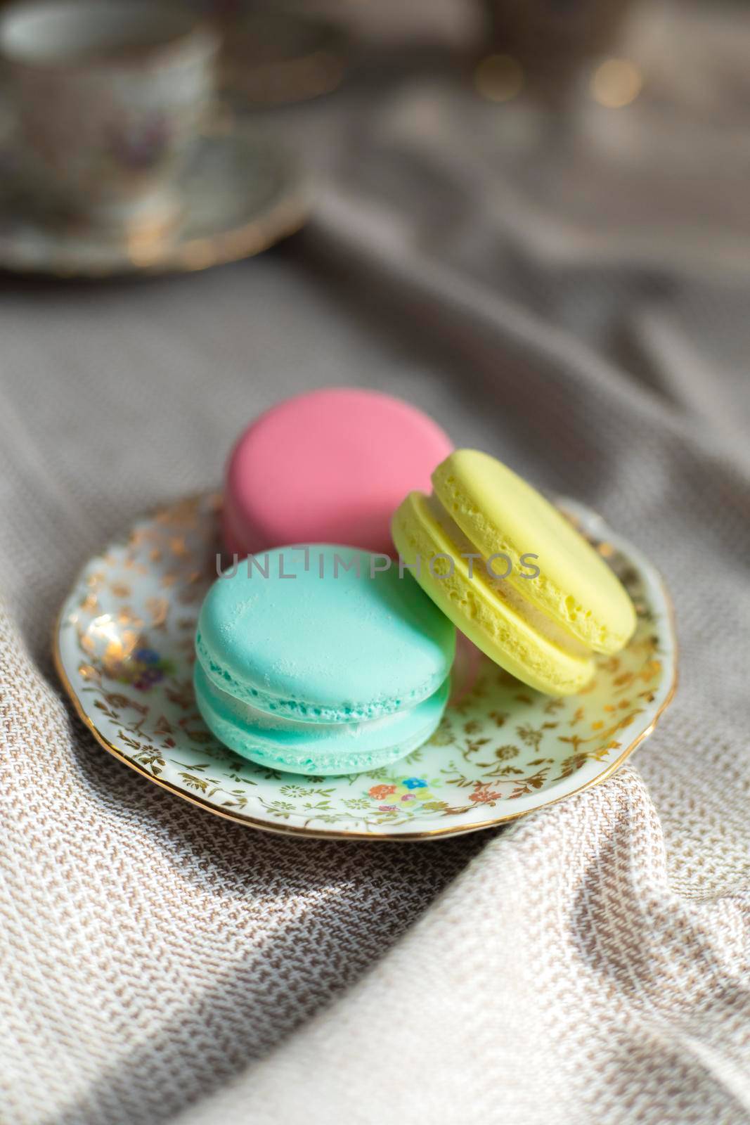 traditional french colorful macarons cookies stand on wooden table,pastel colors macaroons for afternoon tea or coffee copy space