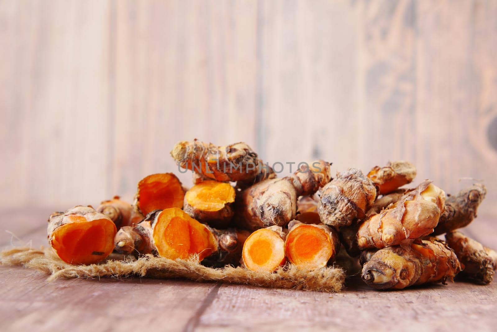 detail shot of turmeric root in bowl on table