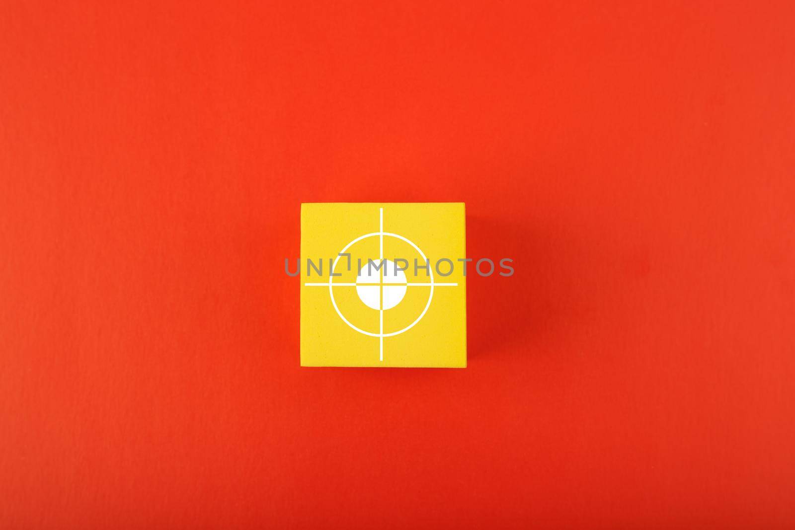 Goal or target symbol on yellow cube in the middle of red background. Concept of scoring a goal by Senorina_Irina