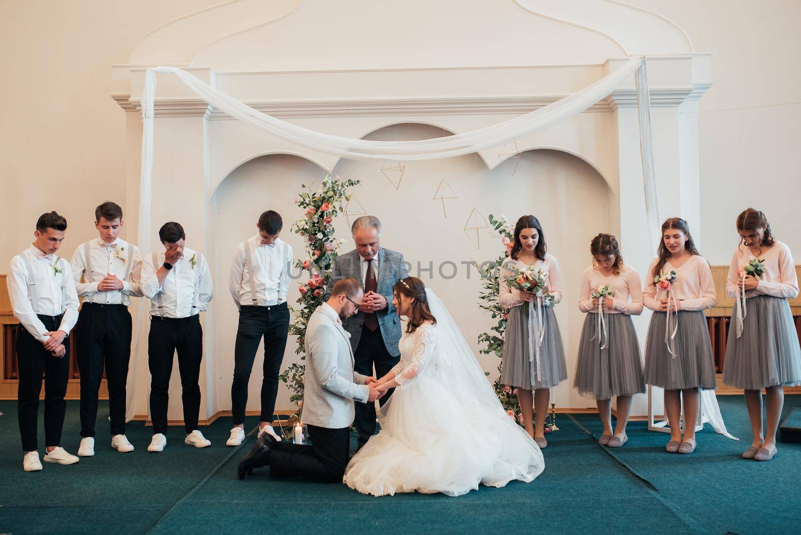 SACRAMENTO, USA - MAY 12 th 2018: Bride and groom pray and receive blessings in the church building.