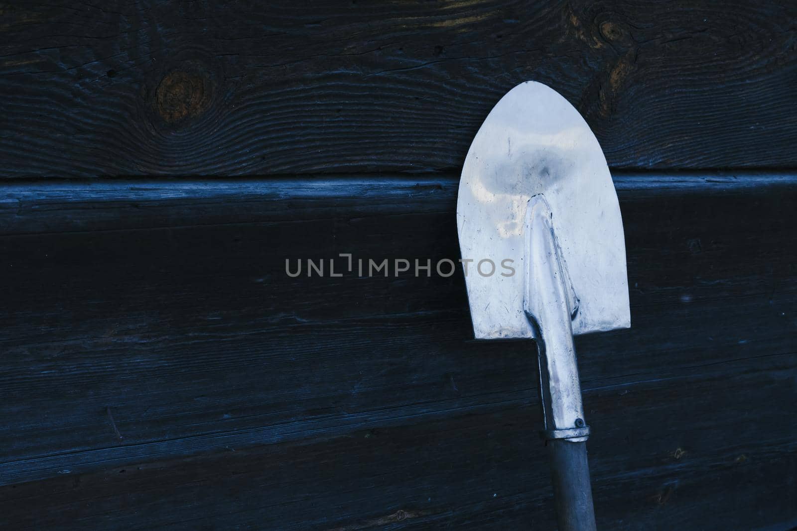 Old rusty shovel prop up against Old wooden wall, Wooden texture background by lunarts