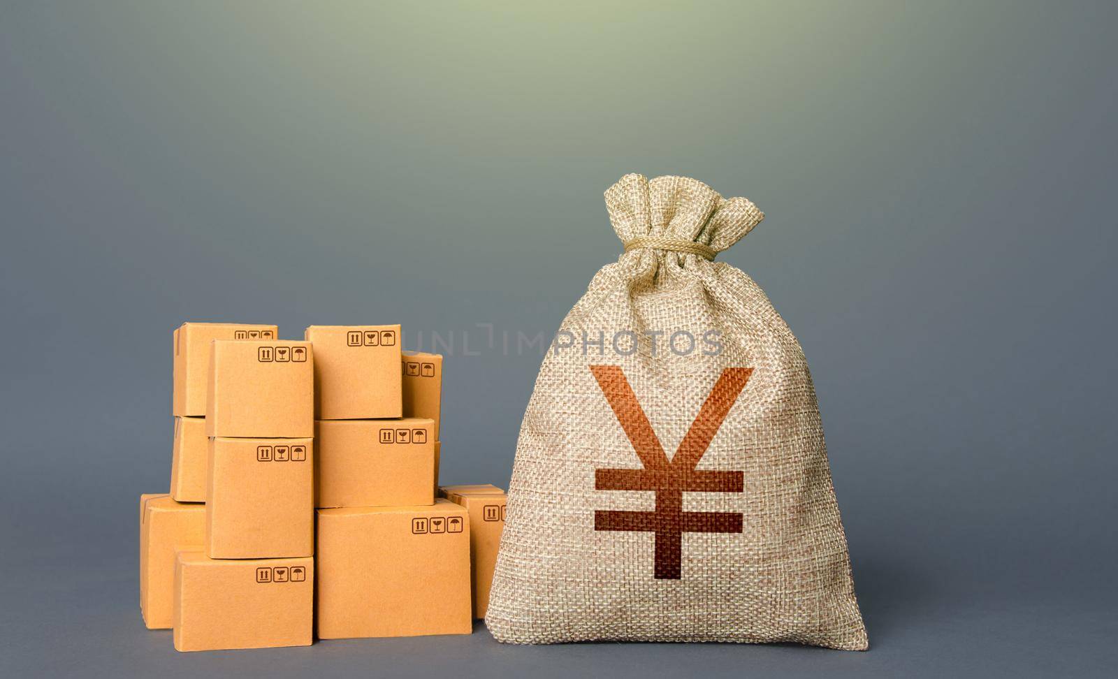 Boxes and chinese yen or japanese yuan money bag. The concept of trade in goods and production. Profit from trading. GDP economy. Import export. Warehousing logistics. Business industry. Delivering.