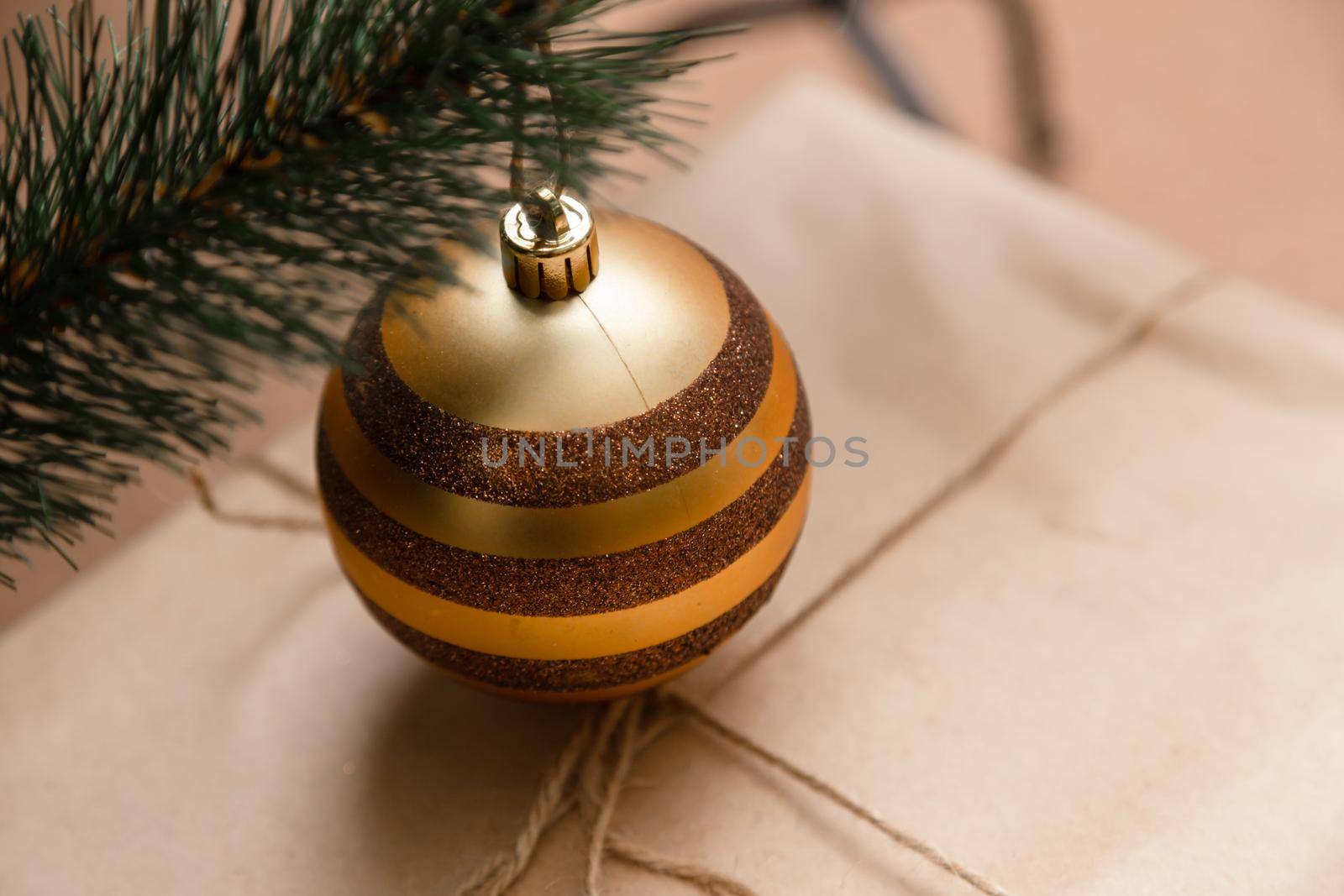 Christmas ball hanging on a christmas tree branch with copy space on white background.