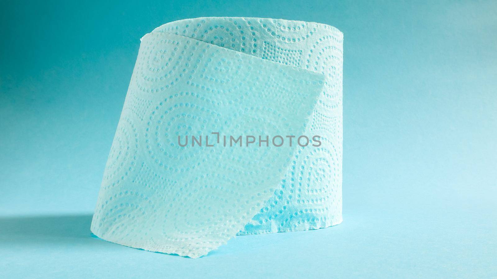 Blue roll of modern toilet paper on a blue background. A paper product on a cardboard sleeve, used for sanitary purposes from cellulose with cutouts for easy tearing. Embossed drawing.