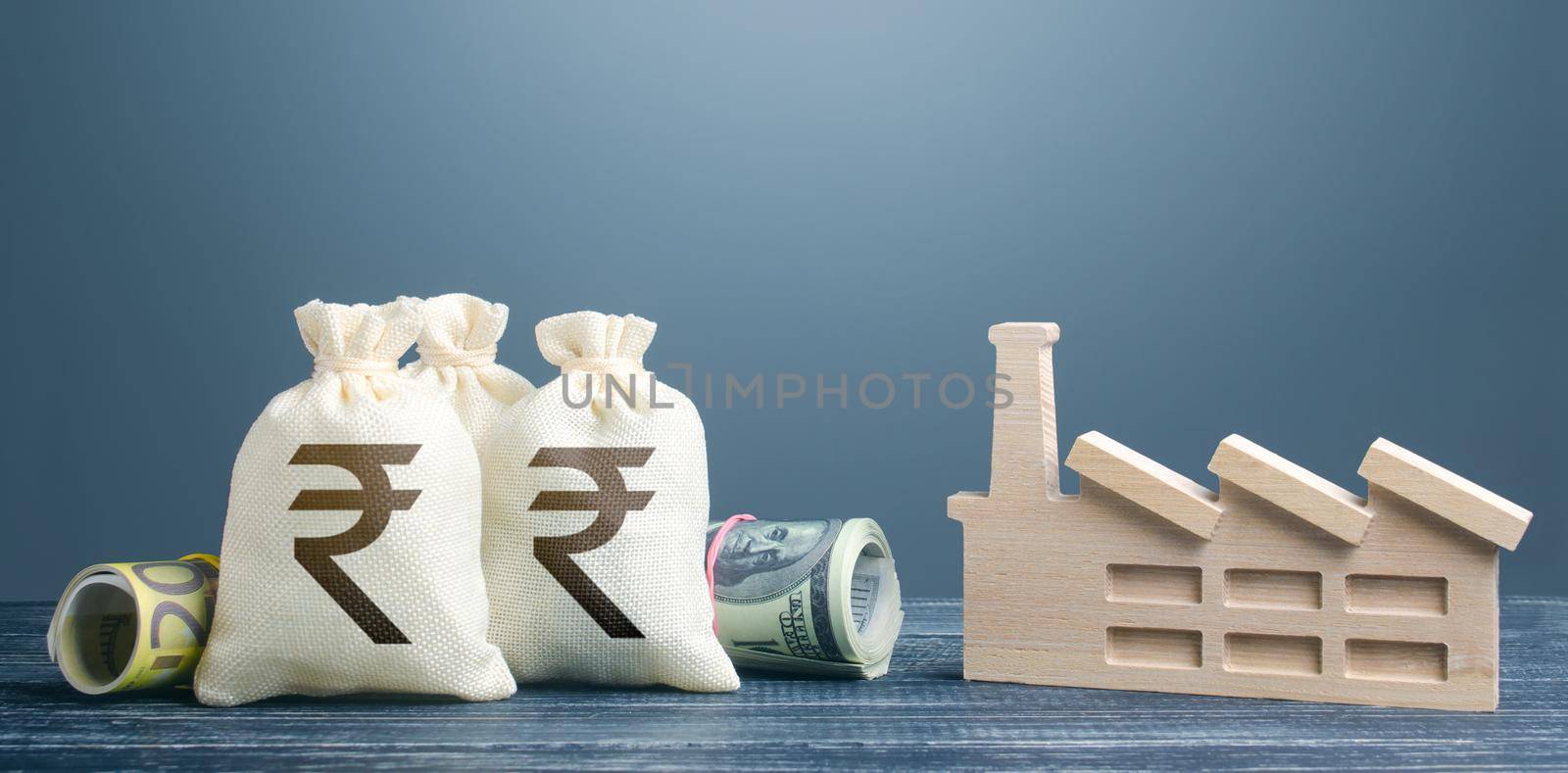 Indian rupee money bags and industrial factory plant. Investments in production and energy industry. Concession auction tender. Budget-forming subjects of economy. Subsidies and support for businesses by iLixe48