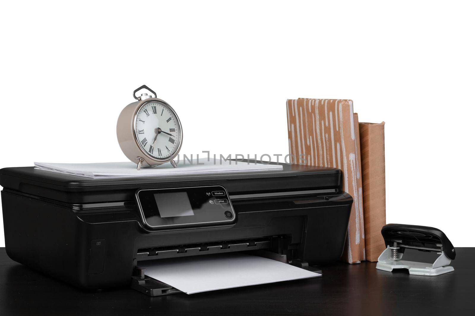 Office table with laser printer and books against white background, close up