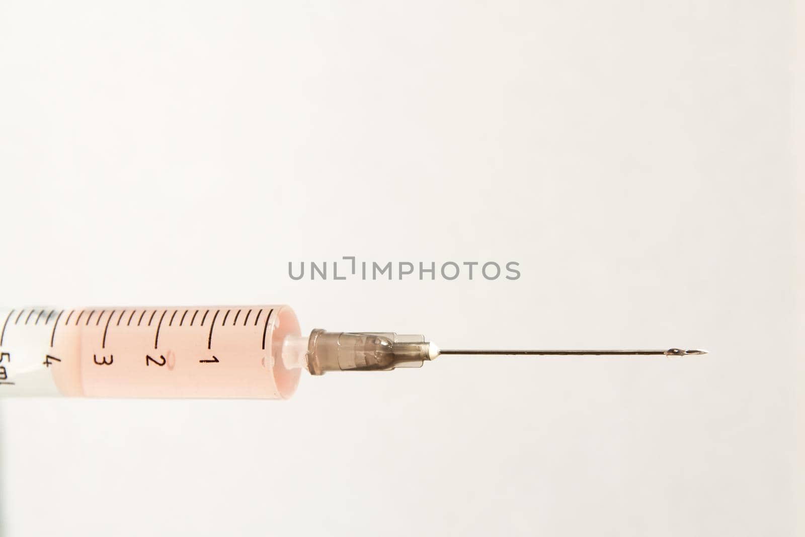 Medical syringe on a light background