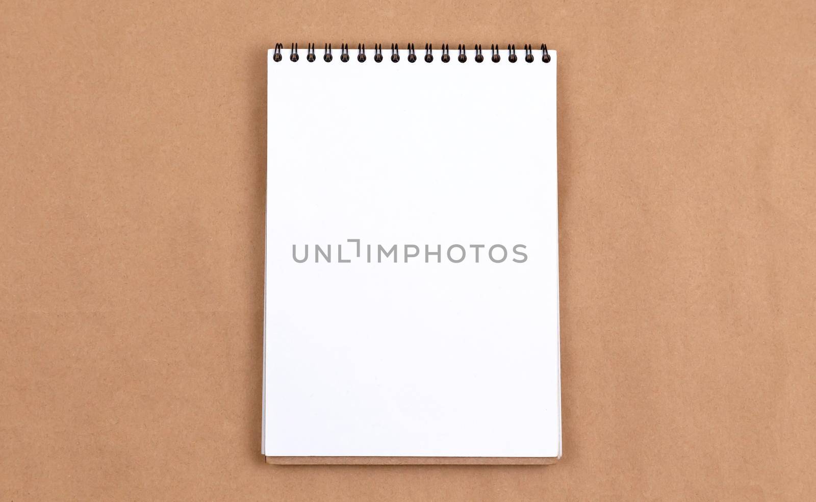Stationary concept, Flat Lay top view Photo of blank notepad on a beige abstract background with copy space, minimal style. by lunarts