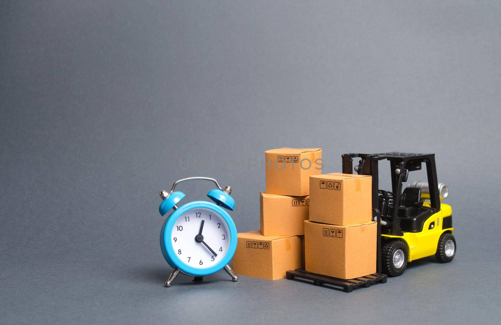 Yellow Forklift truck with cardboard boxes and a blue alarm clock. Express delivery concept. Temporary storage, limited offer and discount. Optimization of logistics and delivery, improving efficiency by iLixe48