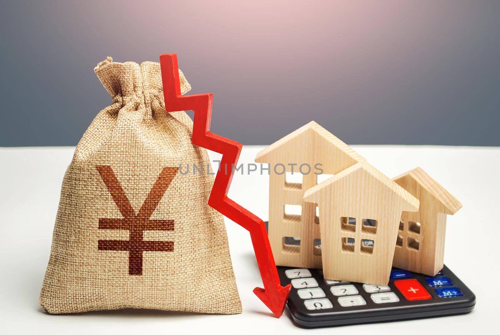 Yuan Yen money bag with down arrow and houses on calculator. Saving resources and reducing maintaining cost, energy efficiency. Falling real estate market, low prices and demand.