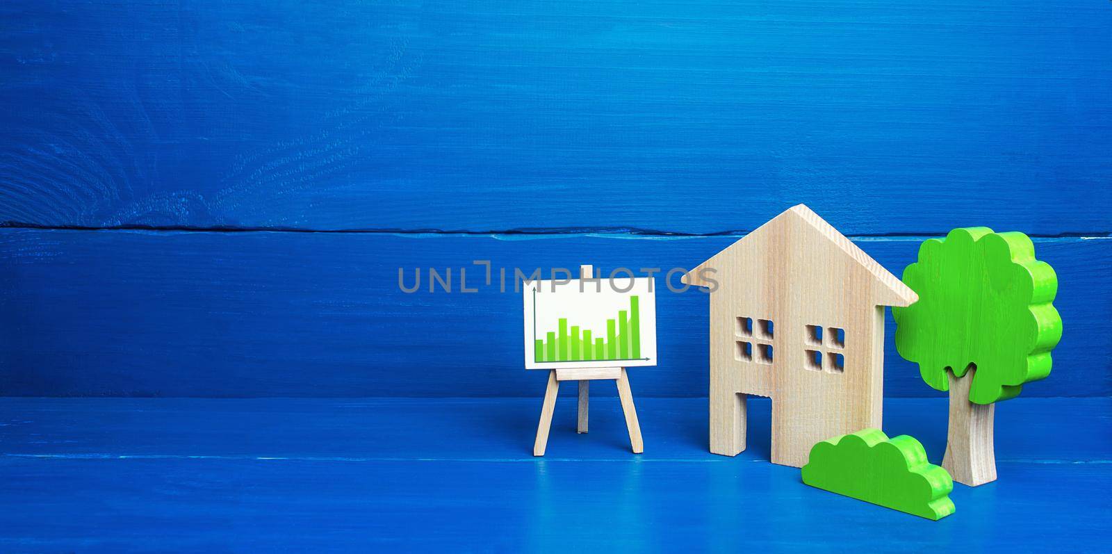 Residential building and easel with green positive upward trend chart. Recovery of the real estate market, growing prices and demand for housing. Growth and development, investment. Energy efficiency by iLixe48