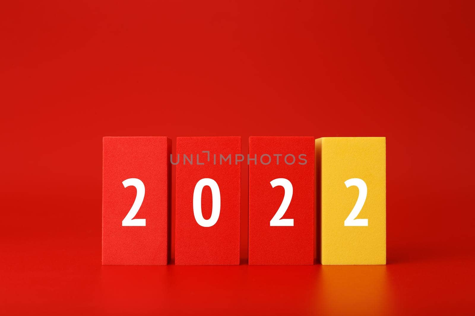 2022 red minimal trendy concept. Modern composition with red blocks with written 2022 numbers against red background with copy space.