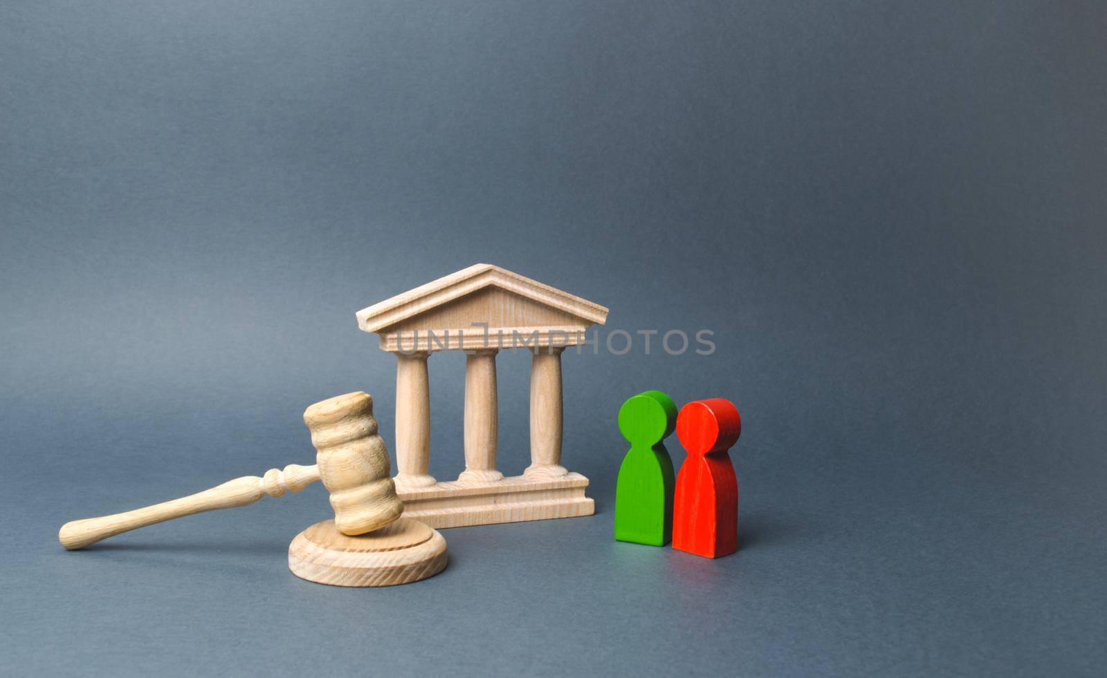 Two figures of people opponents stand near the courthouse and the judge's gavel. The judicial system. Conflict resolution in court, claimant and respondent. Court case, settling disputes.