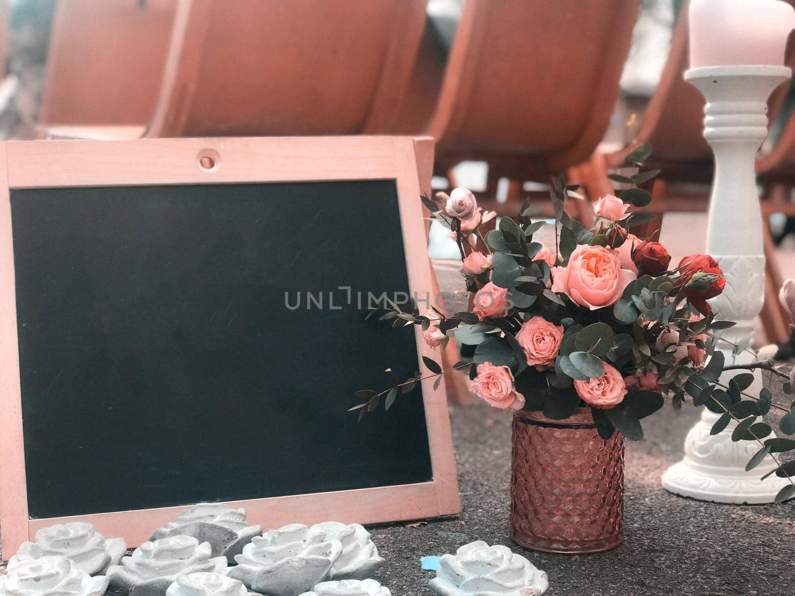 A bouquet in a rustic style with a frame and a black board for drawing a place for text.