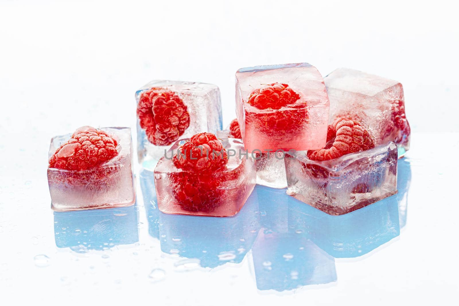 Ice cubes with frozen berries inside close up. High quality photo