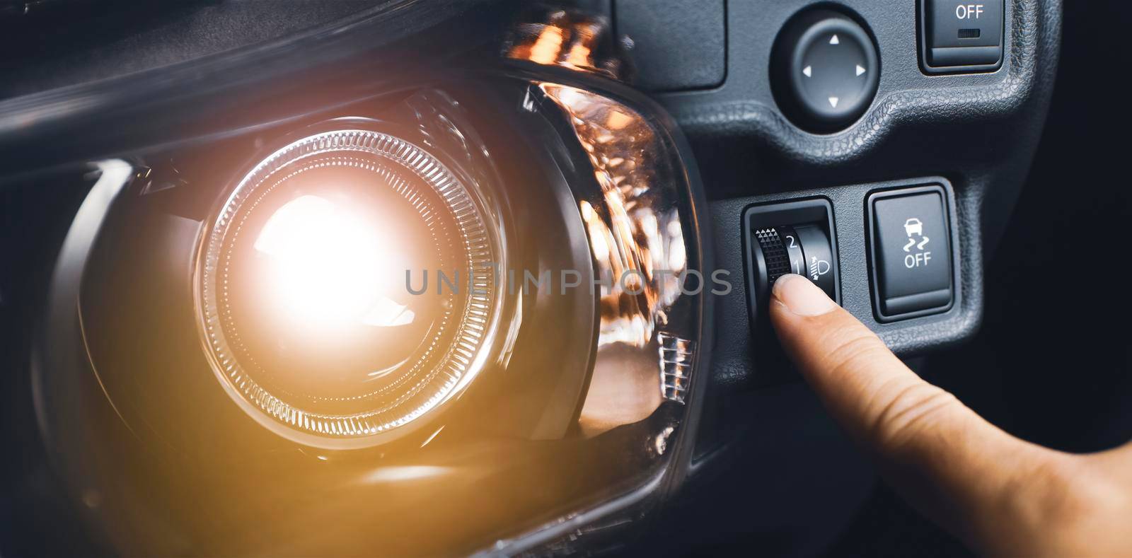 Driver hand adjusting headlight level switch and car headlight bright,Double exposure automotive concept