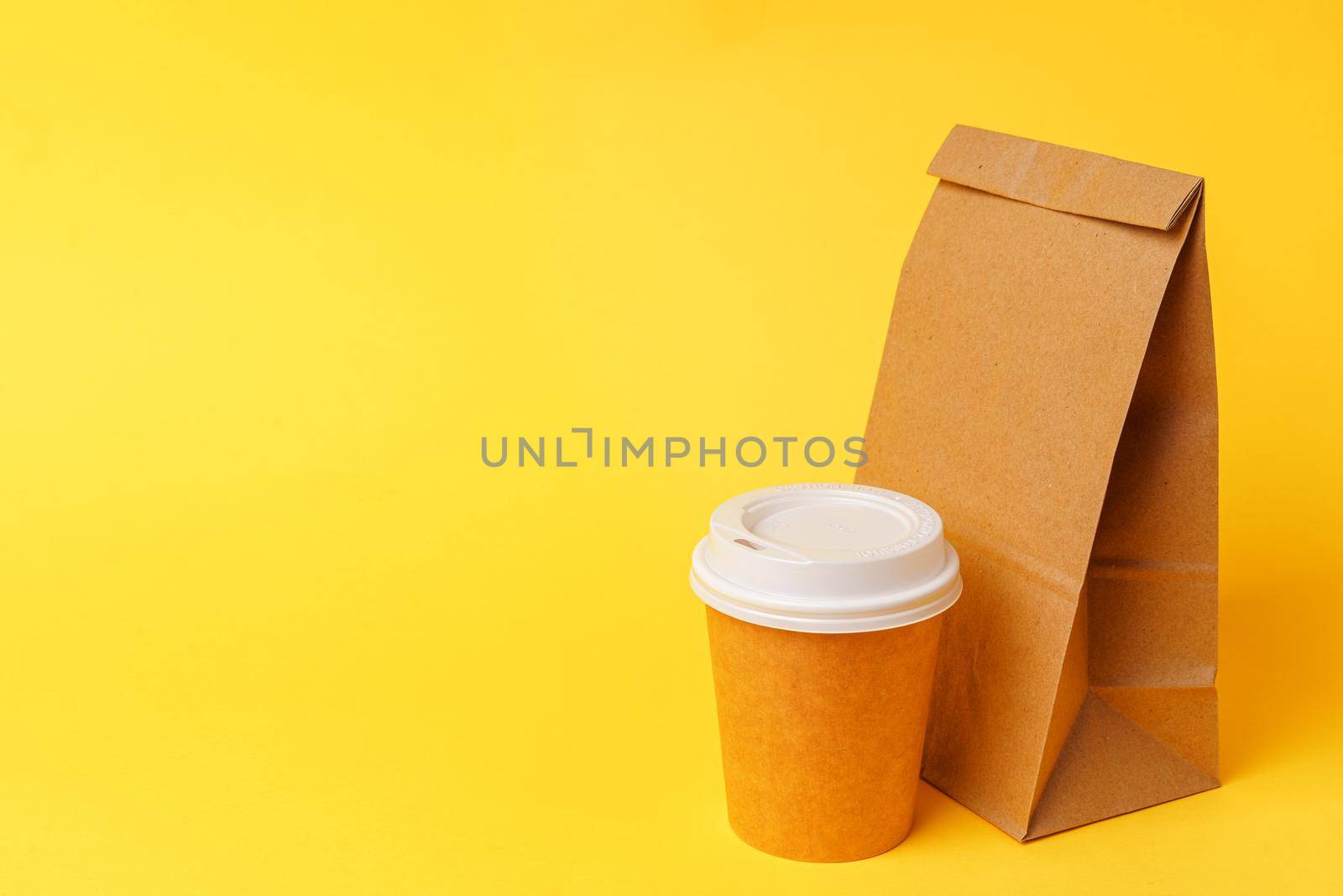 Takeaway food concept. Some packed food in container with coffee cup on table