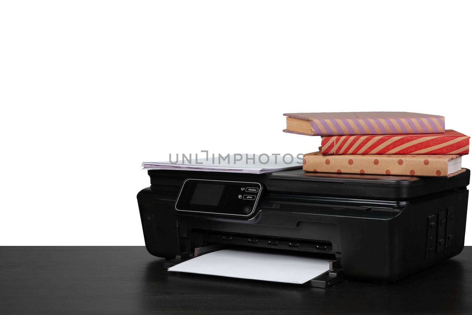 Working table with printer and stacked books on white abckground, close up