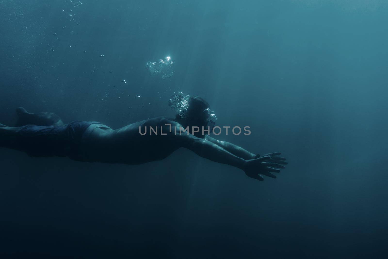 Man swimming underwater, breaststroke. by alexAleksei