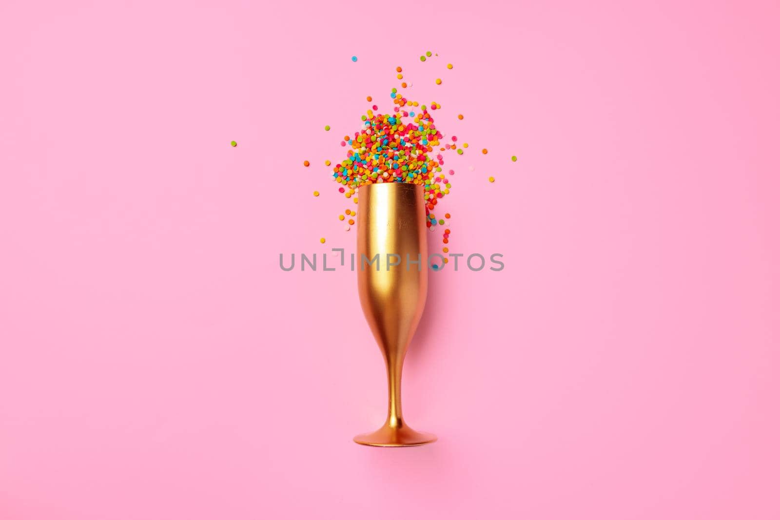 Champagne glass with confetti flat lay top view, christmas background