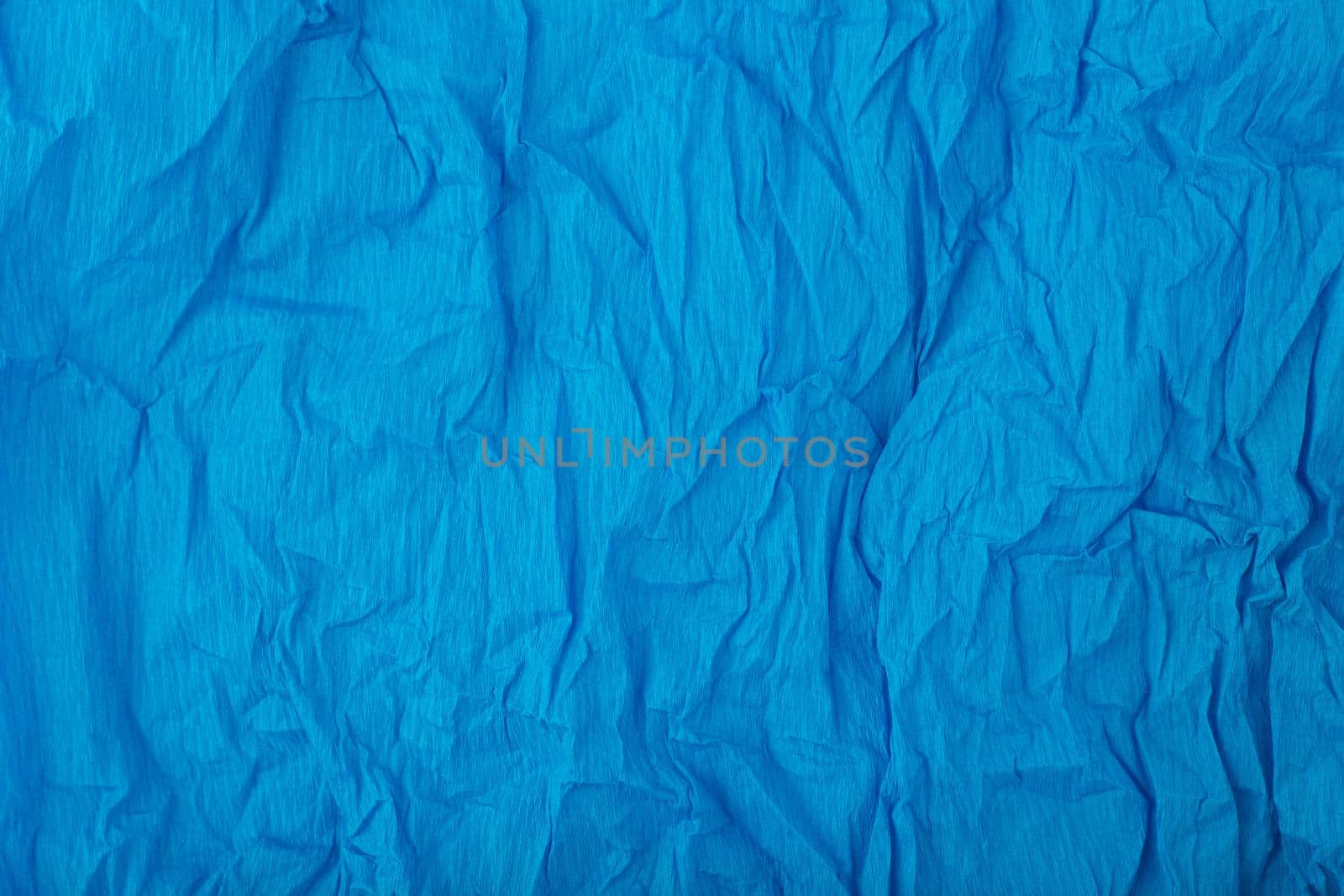 Blue crumpled paper texture background with space for text. Crumpled wrapping paper background. Concept of template for text with high resolution