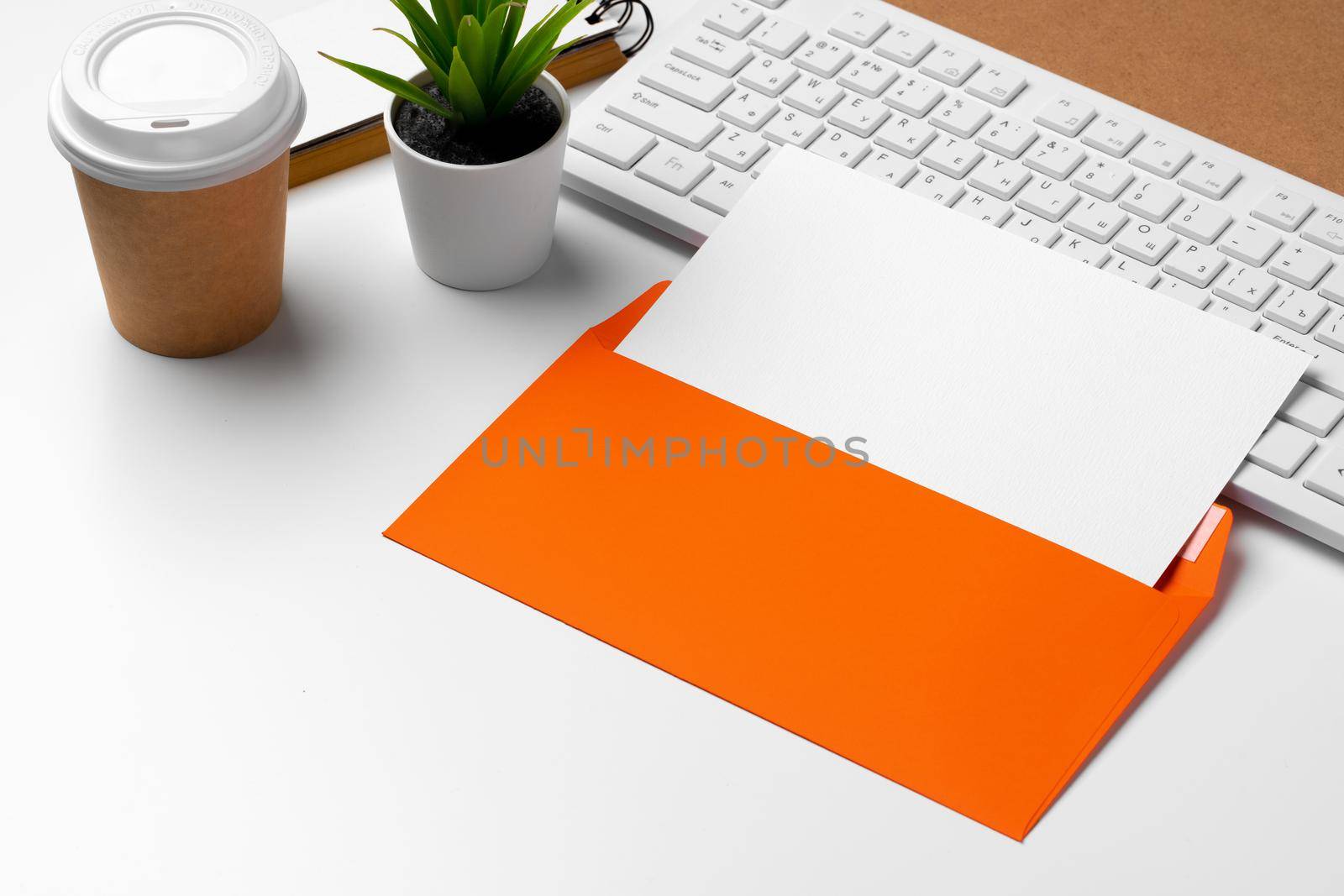 Blank business cards with supplies and keyboard on office table. Close up.