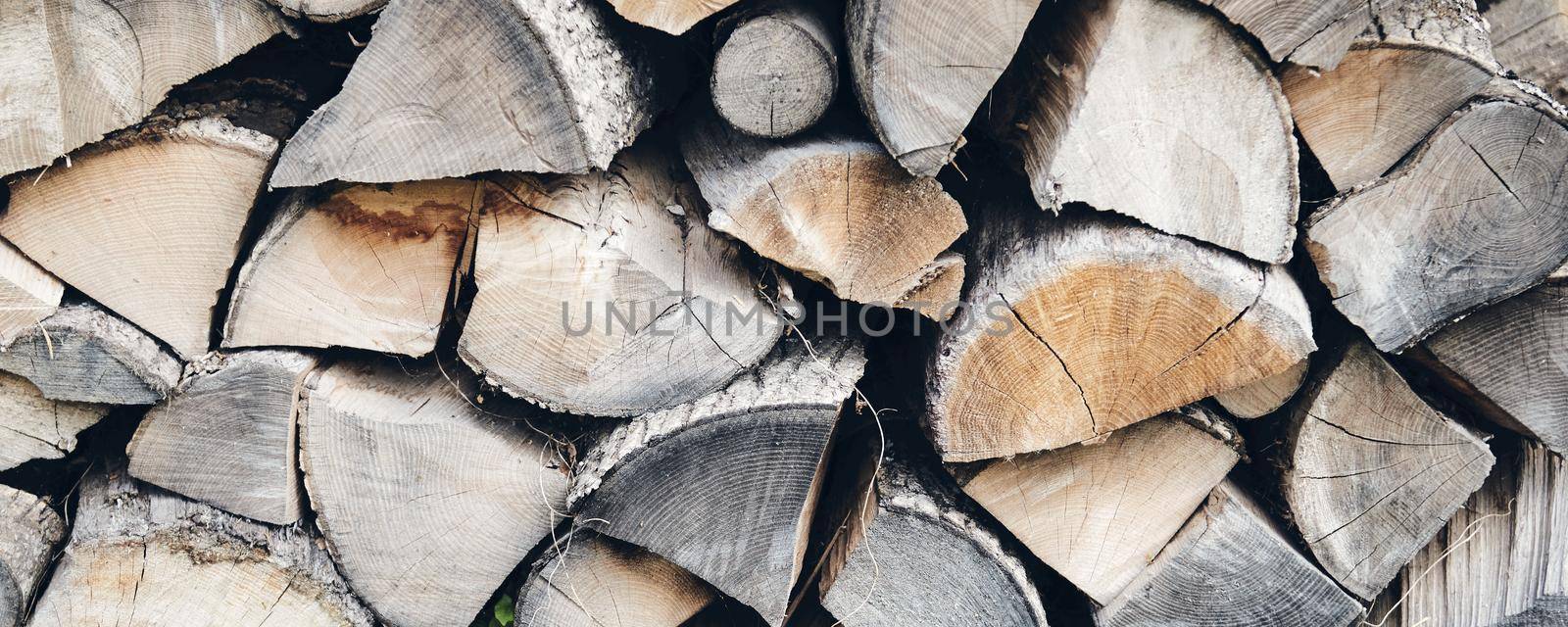 Logs in a sawmill yard. Stacks of woodpile firewood texture background by OneWellStyudio