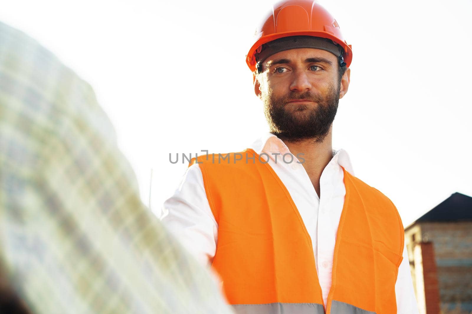 Portrait of young construction engineer wearing hardhat, close up